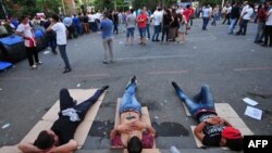 Armenia -- Demonstrators lie on Marshal Bagramian Avenue during a protest against an increase of electricity prices in Yerevan, June 24, 2015