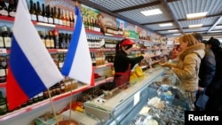 Customers shop at Crimean Farmstead, Russia's first specialized grocery which sells products from annexed Crimea, in the Moscow suburb of Khimki, in January 2015.