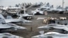 A US Navy officer walks past fighter jets sitting on the flight deck of the Nimitz-class aircraft carrier USS Abraham Lincoln. (file photo)