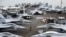 A US Navy officer walks past fighter jets sitting on the flight deck of the Nimitz-class aircraft carrier USS Abraham Lincoln. (file photo)