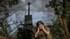 Ukrainian servicemen fire a self-propelled howitzer toward Russian positions on a frontline in the Zaporizhzhya region