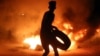 A demonstrator burns tires during protests in the southern Iraqi city of Basra on July 12. 