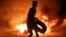 A demonstrator burns tires during protests in the southern Iraqi city of Basra on July 12. 