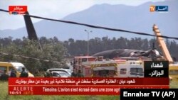 A video grab shows emergency services working at the scene after a military plane crashed soon after takeoff at Boufarik military base on April 11.