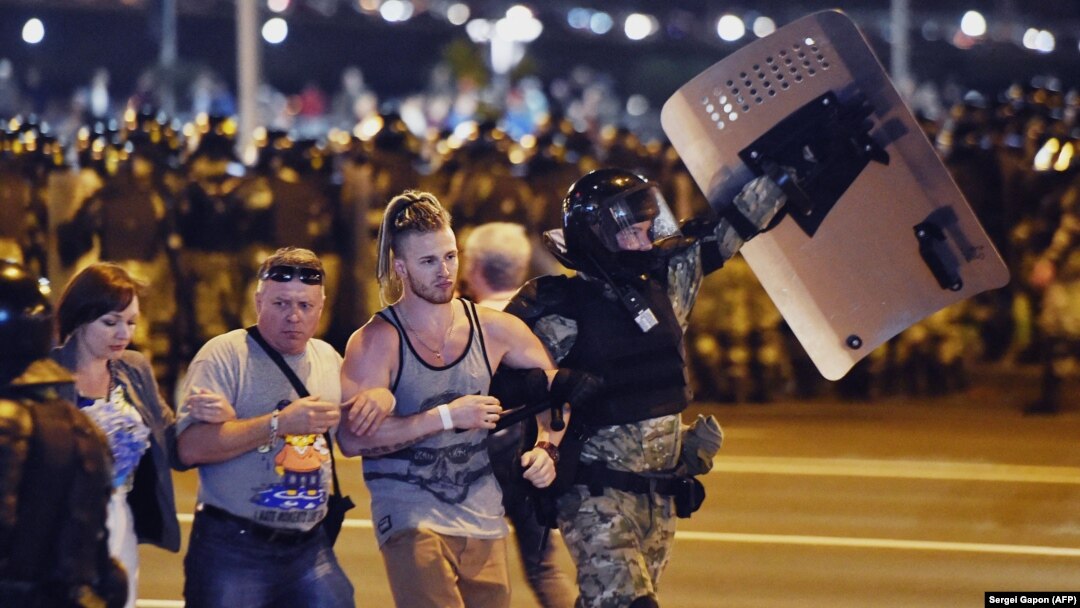 Riot police detain a group of demonstrators during a protest after polls closed in Belarus's presidential election in Minsk on August 9, 2020. 