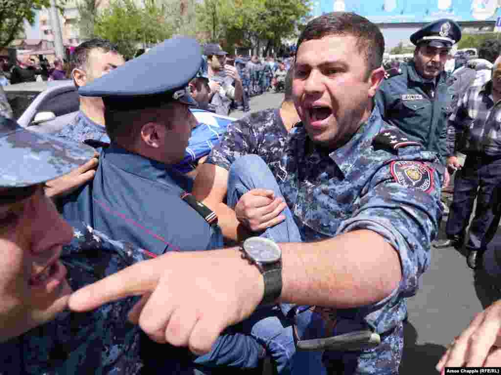 More than 100 protesters were detained in downtown Yerevan after scuffles with riot police that had cordoned off a major government building on April 19 -- the seventh day of street protests against the election of longtime former President Serzh Sarkisian as prime minister. (Amos Chapple/RFE/RL)