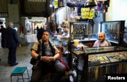 Vendors sit at their shops selling jewelry and accessories at Tehran's Grand Bazaar on April 13.