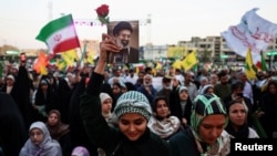 A woman holds an image of Iranian Supreme Leader Mojtaba Khamenei at a rally in Tehran on June 4.