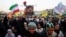 A woman holds an image of Iranian Supreme Leader Mojtaba Khamenei at a rally in Tehran on June 4.