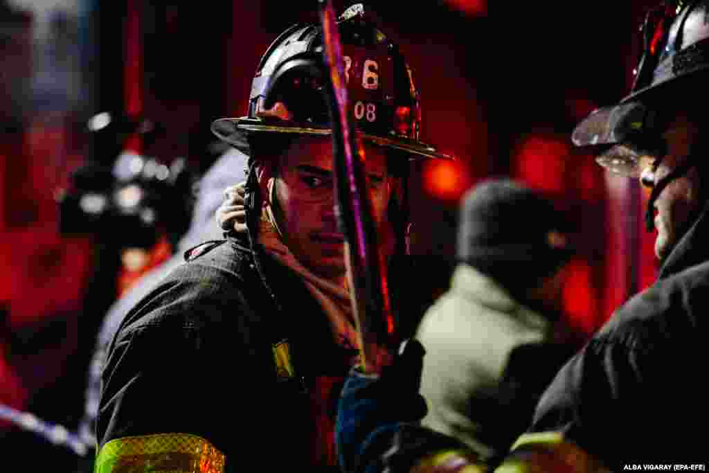 Firefighters work at the scene of a four-alarm fire at an apartment building in the Bronx in New York City. At least 12 people were killed, including a 1-year-old child. Mayor Bill de Blasio said it was the worst fire tragedy the city had seen in 25 years. (epa-EFE/Alba Vigaray)