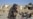 A Taliban security officer stands near a damaged house in Kandahar province on October 16.