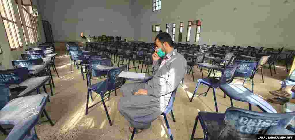 A staff member sits in an deserted examination hall as authorities canceled exams in all education institutes throughout Balochistan, Pakistan after the first case of coronavirus in the region was confirmed. (epa-EFE/Jamal Tarakai)&nbsp;