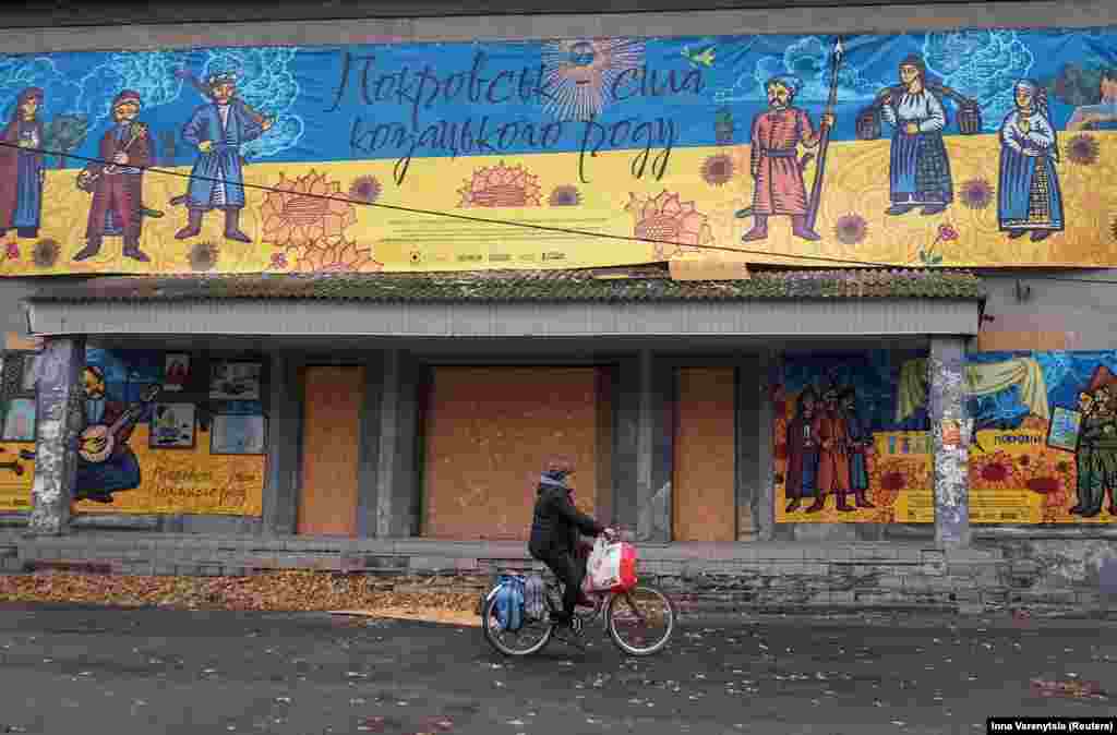 A resident rides a bicycle amid Russia&#39;s attack on Ukraine in the town of Pokrovsk in the Donetsk region.