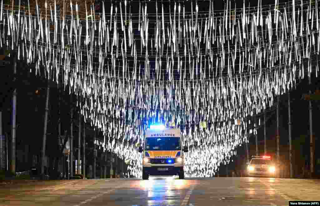 An ambulance is seen under Christmas and New Year&#39;s decorations during a nighttime curfew imposed by the Georgian government amid the ongoing coronavirus disease pandemic in Tbilisi. (AFP/Vano Shlamov)