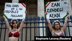 Women in Paris express solidarity with an Iranian woman who was arrested outside her Tehran university.