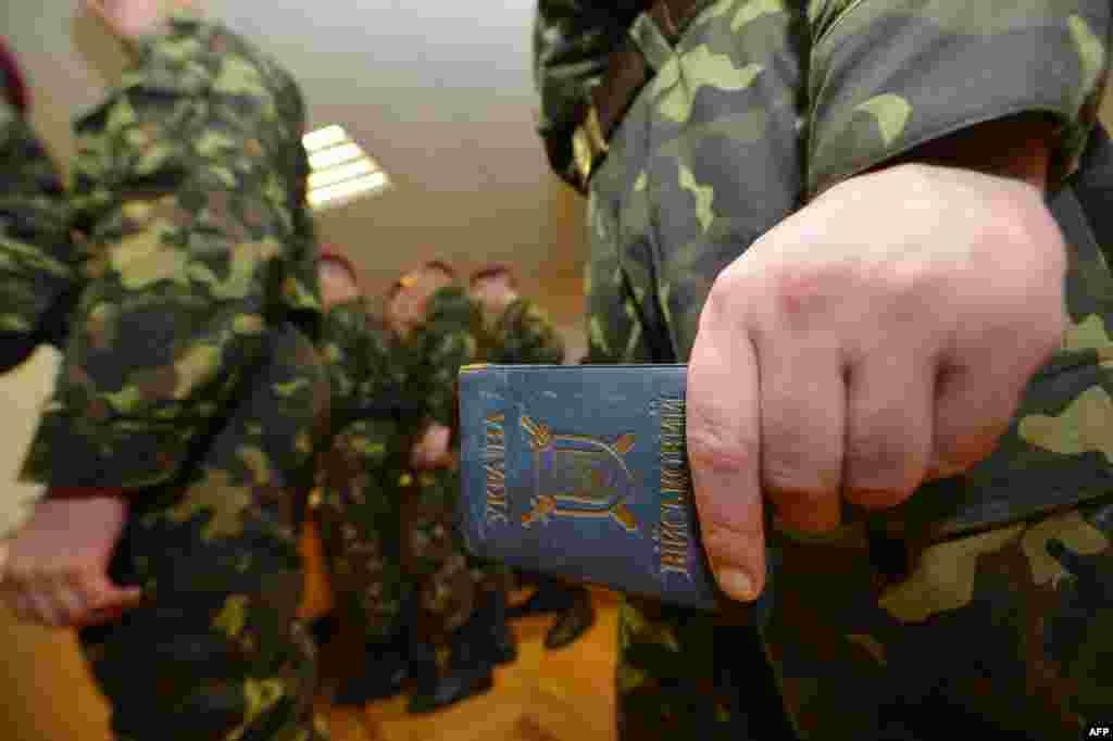 Ukraine - A soldier from the President's Regiment holds an ID during Parliament elections in Kiev on October 28, 2012.