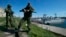 Russian soldiers guard a pier where two Ukrainian naval vessels are moored in Sevastopol, Ukraine, in March 2014.