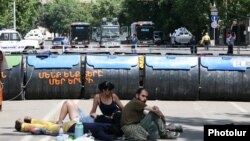 Armenia - Protesters sit and lie on the ground behind a barricade built on Marshal Bagramian Avenue, Yerevan, 29Jun2015.