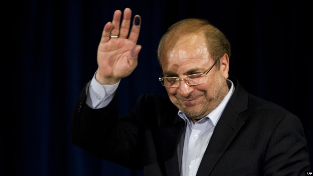 Mohammad Baqer Qalibaf waves after registering his candidacy for the June presidential election.