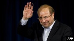 Mohammad Baqer Qalibaf waves after registering his candidacy for the June presidential election.