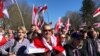 People gathered in a local park for the event, singing patriotic songs and waving flags of the Belarusian People’s Republic.