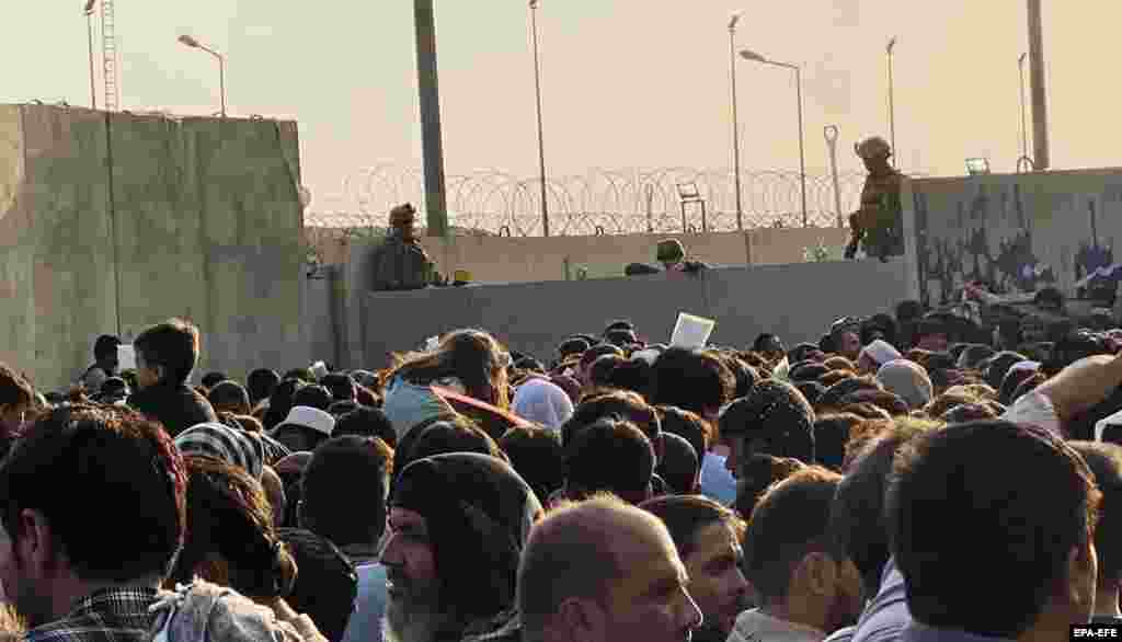 People attempt to get into the airport in Kabul in order to flee the country on August 23.