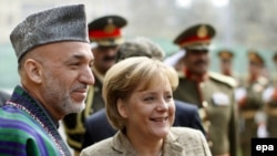 Afghan President Hamid Karzai and German Chancellor Angela Merkel (file photo)