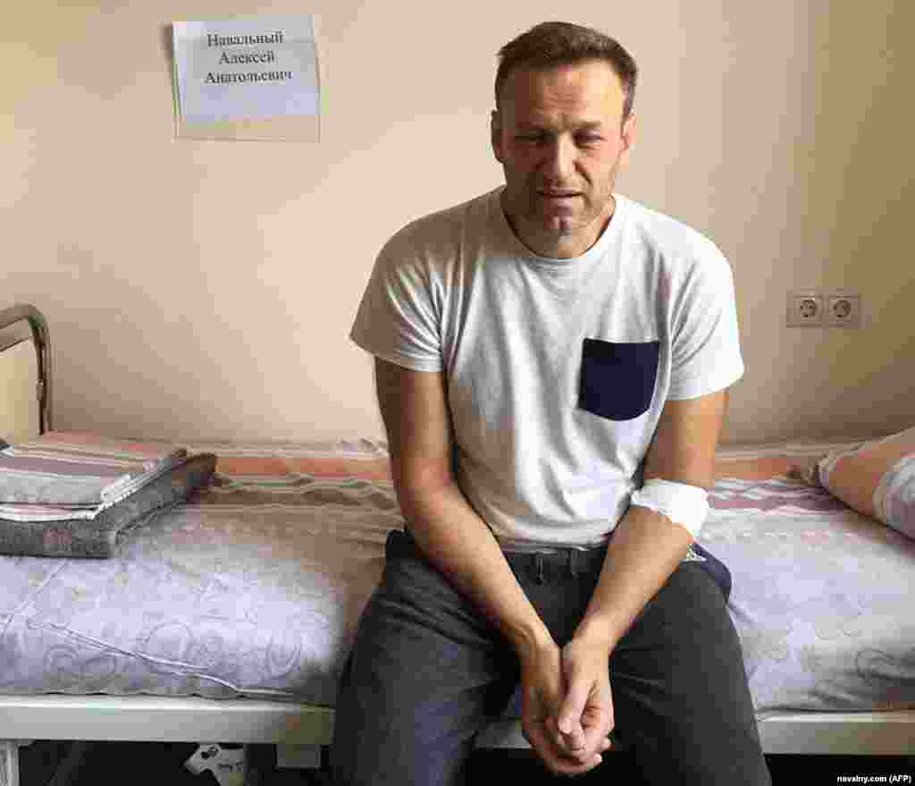 Navalny, his eyes red and puffy, sits on a hospital bed in Moscow on July 29, 2019, after feeling unwell in his Moscow cell while serving a prison term on charges of calling an unauthorized rally. He said he believed he&#39;d been poisoned. Doctors attributed it to an &quot;acute allergic reaction.&quot;