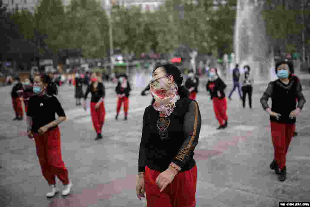 CHINA XINJIANG LEISURE -- People gather to dance in century square in Aksu, western China's Xinjiang Uyghur Autonomous Region during a government organized trip for foreign journalists, 20 April 2021. Lying at the northern edge of the Tarim Basin, the eco