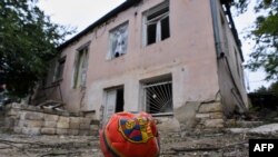 NAGORNO-KARABAKH - A ball lies on the ground in front of a house damaged by shelling in the town of Martuni, October 1, 2020.