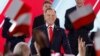 Karol Nawrocki, candidate for the 2025 Polish presidential election supported by Poland's right-wing Law and Justice (PiS) party, addresses supporters as exit polls were announced during their election night event at the Mala Warszawa Theatre in Warsaw, P