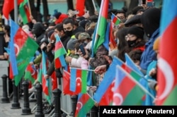 A sea of Azerbaijani flags among the spectators. The truce allows Azerbaijanis who left their homes in the 1990s conflict to return, but it has also led to an exodus of ethnic Armenian civilians.