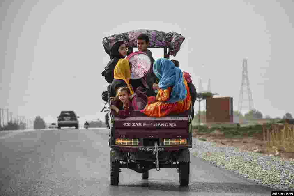 Afghan children travel on a three-wheel vehicle in Balkh Province.&nbsp;