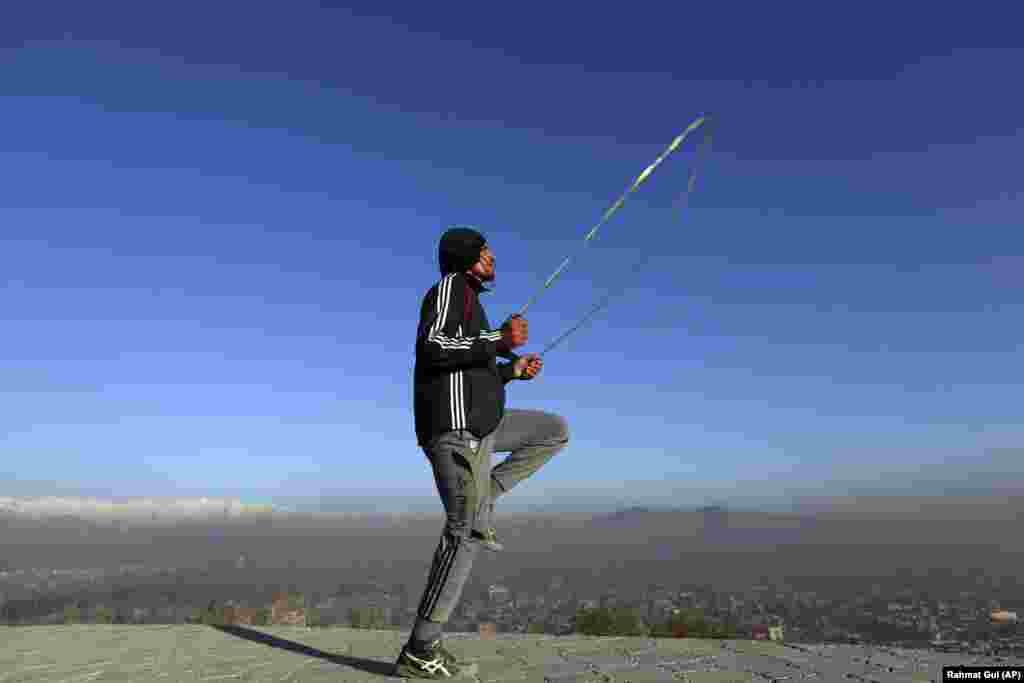 An Afghan youth exercises in the early morning on a hilltop in Kabul. (AP/Rahmut Gul)