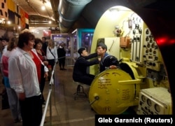 Tourists in May 2010 view a mockup of a submarine compartment inside the Balaklava base when it served as a Ukrainian museum.