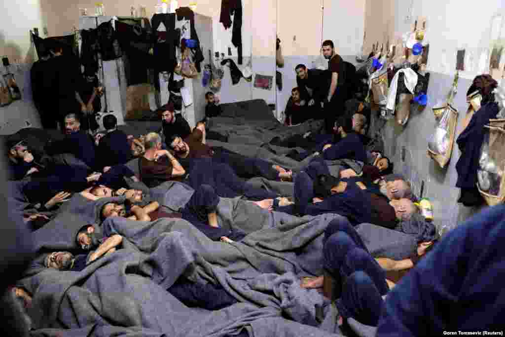 Suspects lie in a prison cell in Hasaka, Syria.