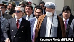 The chairman of the High Council for National Reconciliation of Afghanistan, Abdullah Abdullah (left), is seen with Afghan political leaders and members of the negotiating team as they depart for Russia.