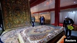 People look at carpets displayed at the Iran section of the Baghdad International Fair, in Baghdad, Iraq November 10, 2018. File photo