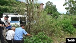 Investigators at the site of a June 29 blast at Gagry