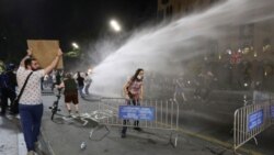 Water cannon is used against protesters in Georgia opposed to a 'foreign agent' bill.