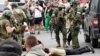 Members of the Wagner group detain a man in the city of Rostov-on-Don on June 24.