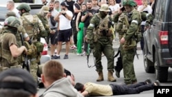 Members of the Wagner group detain a man in the city of Rostov-on-Don on June 24.