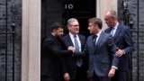 Ukrainian President Volodymyr Zelenskyy (left) shakes hands with French President Emmanuel Macron in front of 10 Downing Street after a meeting in London that was also attended by UK Prime Minister Keir Starmer (second left) and German Chancellor Friedrich Merz (right) on December 8