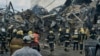 Emergency service personnel work at the site of a destroyed building in Odesa on July 20 after Russia pounded the Ukrainian port city with drones and missiles for a third consecutive night.