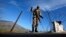 A soldier creates a barrier using barbed wire at a security checkpoint in the Swat valley region. (file photo)