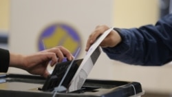 KOSOVO -- A woman casts her vote at a polling station in Pristina, Kosovo, October 6, 2019. 