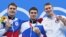 Yevgeny Rylov (center) of Russia won gold, Kliment Kolesnikov (left) of Russia won silver, and Ryan Murphy of the United States won bronze in the men's 100-meter backstroke swimming event in Tokyo.