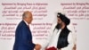 U.S. Special Representative for Afghanistan Reconciliation Zalmay Khalilzad and Taliban co-founder Mullah Abdul Ghani Baradar shake hands after signing a peace agreement during a ceremony in the Qatari capital Doha on February 29.