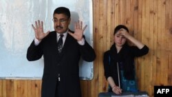 Nineteen-year-old Afghan Negina Khpalwak, right, stands alongside Afghan musicologist Ahmad Sarmast as she conducts her musicians during a rehearsal at the Afghanistan National Institute of Music of Kabul.