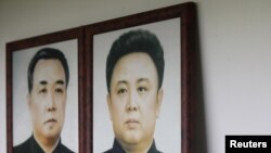 Portraits of North Korea's founder and former leader Kim Il Sung (left) and his son and current leader Kim Jong Il. No confirmed photos exist of Kim Jong Il's presumed successor, his son Kim Jong Un.